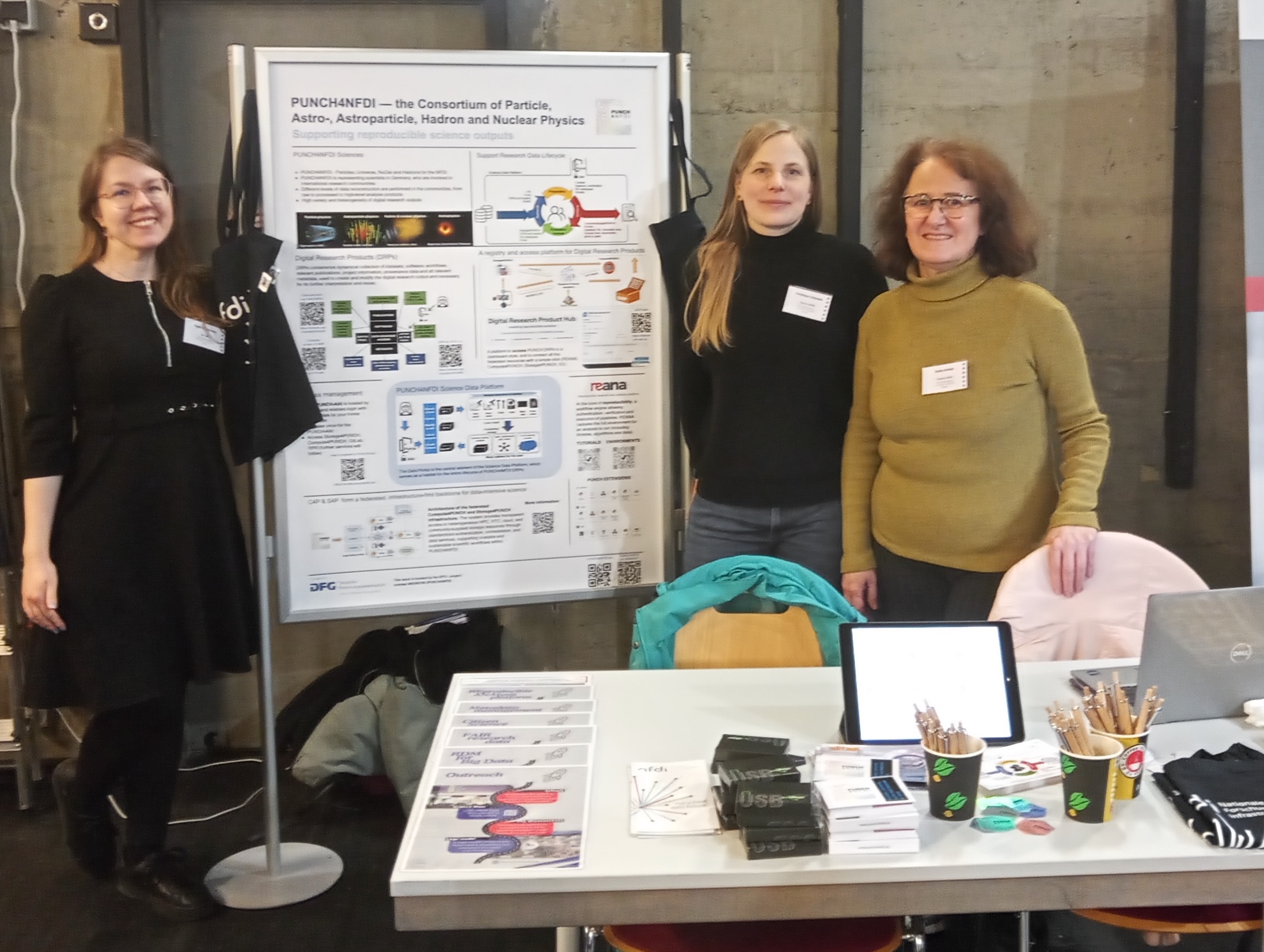 Members of the PUNCH4NFDI Consortium at the booth during the conference